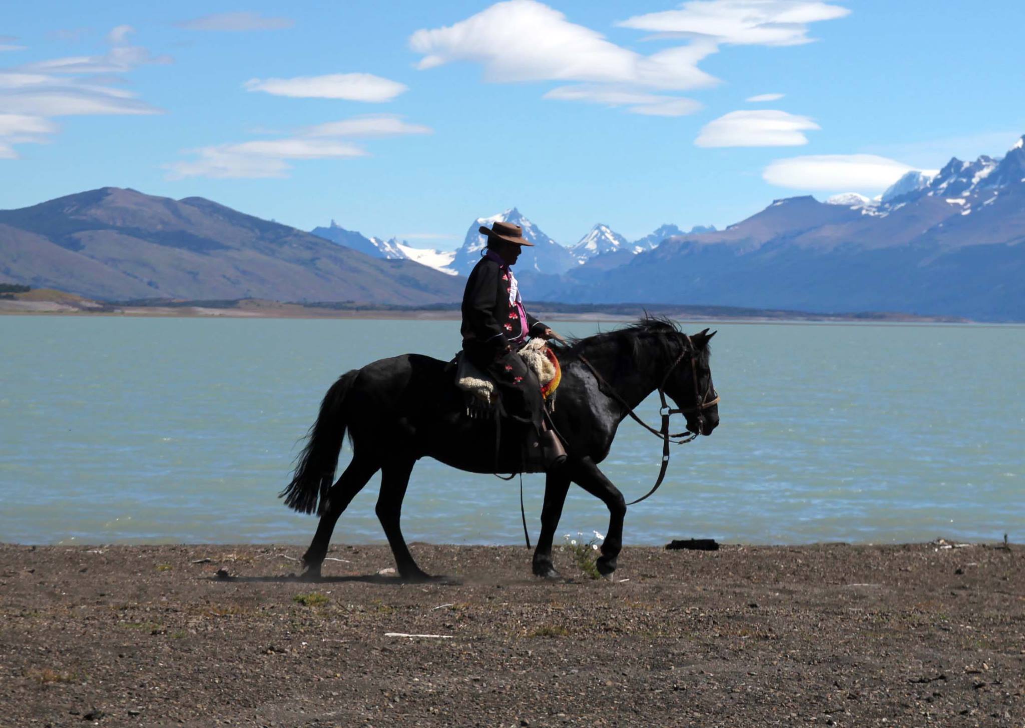 Gaucho riding at lake shore